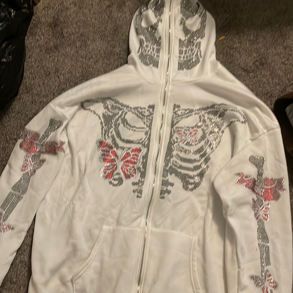 never been worn off white zip up jacket with diamonds skeleton face